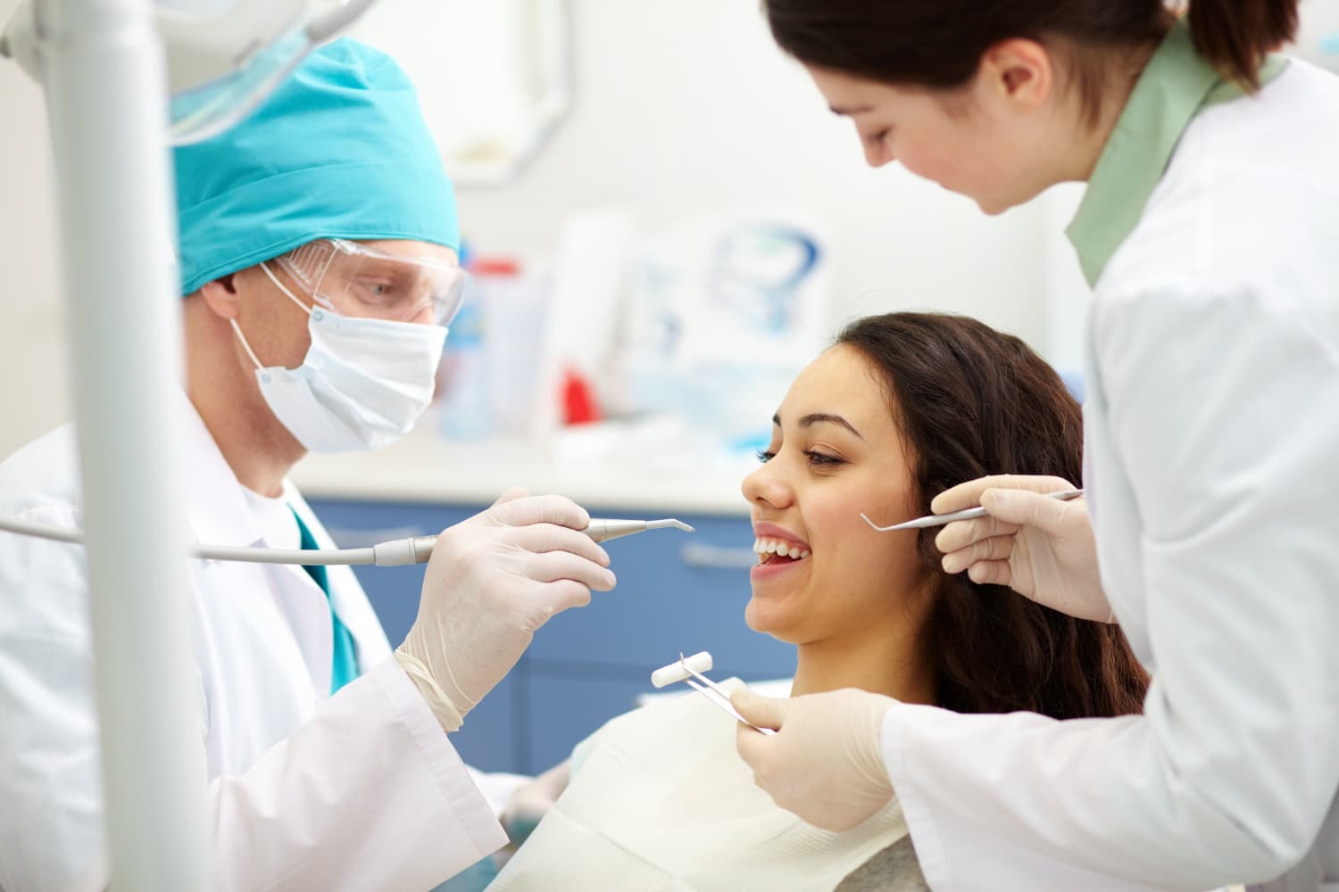 At Carpinello Orthodontics in Drexel Hill, Newtown Square or Edgmont, PA, a team checks a smiling woman’s teeth for tongue thrust.