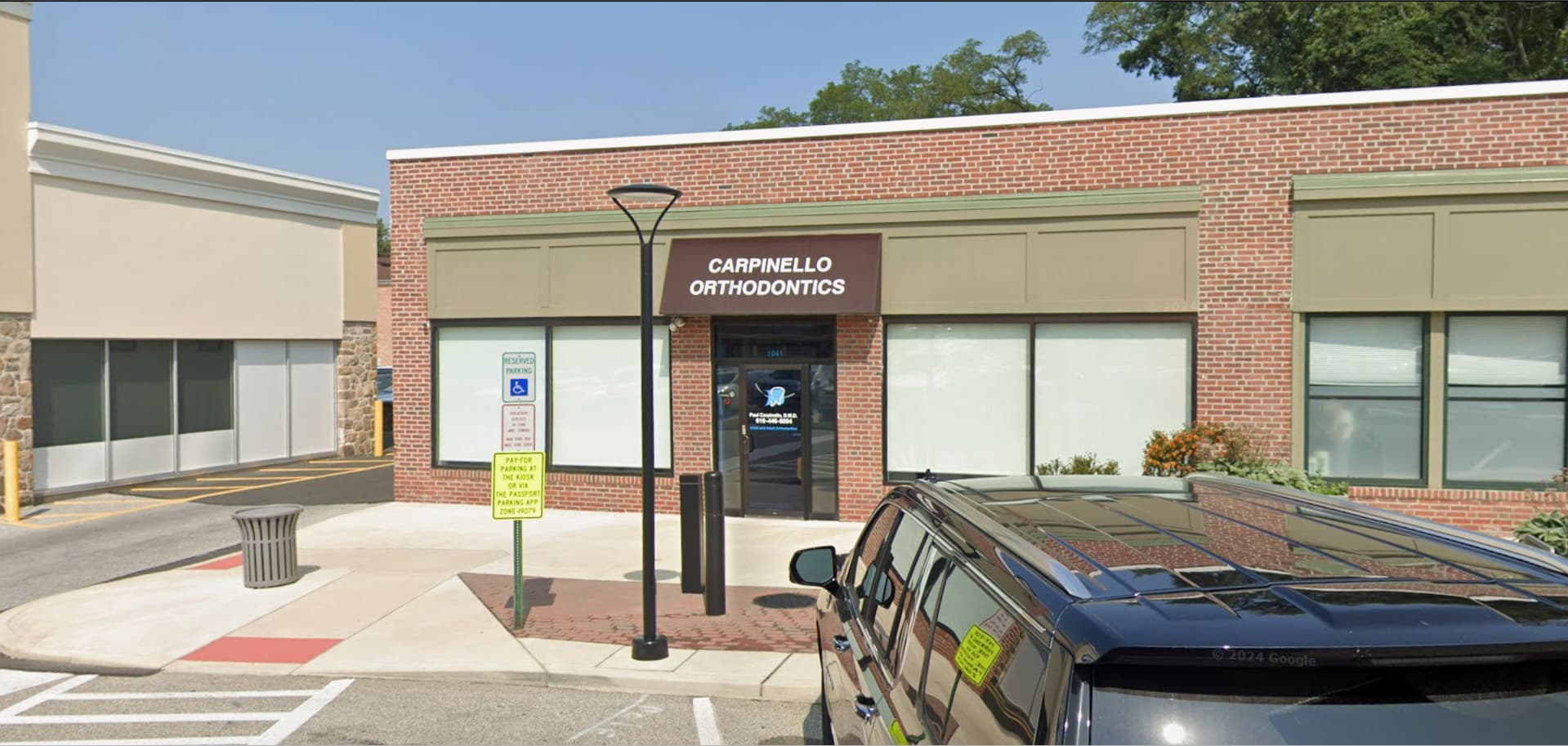 A brick building with "Carpinello Orthodontics" promoting a top-rated orthodontist in Drexel Hill, Newtown Square or Edgmont, PA.